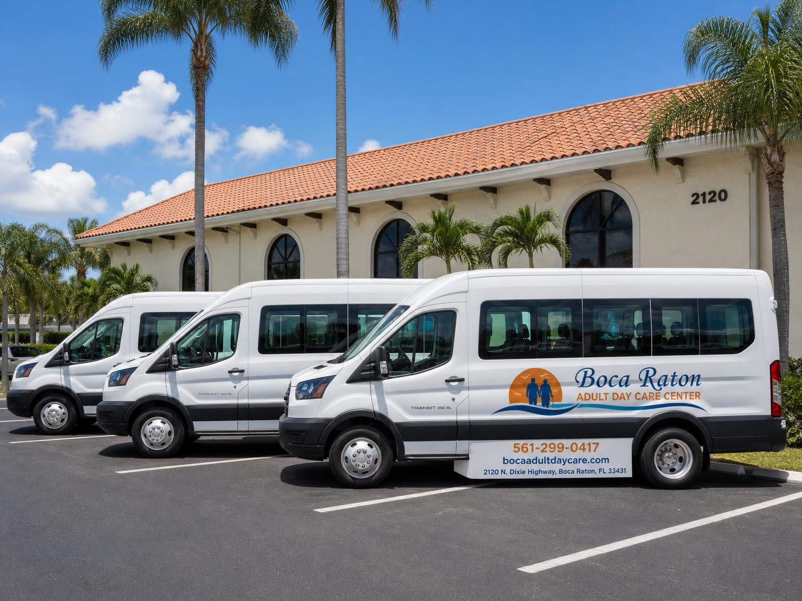Three white 15-passenger Boca Raton Adult Daycare transportation vans parked in front of the center at 2120 N. Dixie Highway
